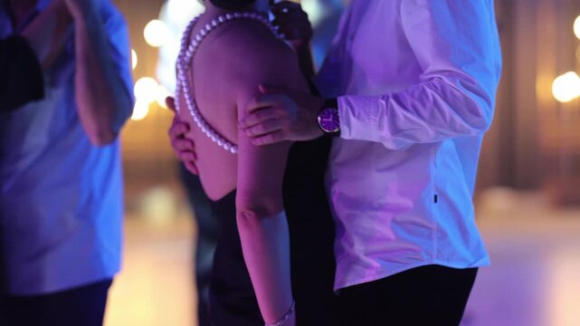 Pairs navigate elegantly through warm glowing surroundings