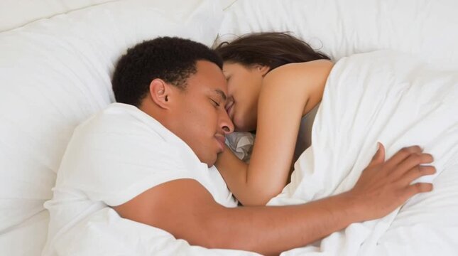 A mixed couple of lovers early in the morning: a mixed-race guy and his Caucasian girlfriend have moment of intimacy. Sexual life of interracial youth