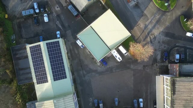 Lostwithiel, Cornwall, England: DRONE VIEWS: Overhead views of factory buildings powered by mass on-roof solar panels. The UK Government has plans for net zero carbon emissions by 2030 (Clip 1 of 3).