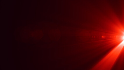 Bright sun flare with red light rays and soft glow emerging from a dark background. Ideal for cinematic visuals, transitions, overlays, or abstract design projects.