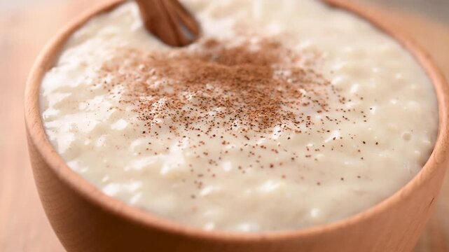 Rice pudding on wooden bowl. Close up