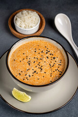 Creamy sesame soup with rice and lime