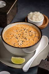 Creamy sesame soup with rice and lime
