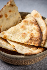 Crispy flatbread wedges in rustic bowl