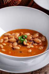 Traditional bean stew in white bowl
