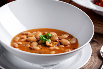 Traditional bean stew served in white bowl