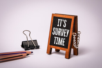 It's Survey Time Displayed On Small Wooden Sign With Pencils And Clip Nearby