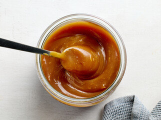 glass jar of freshly cooked homemade caramel sauce