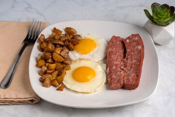 fried eggs  with  home fries and smoked sausage