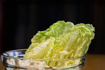 Fresh of napa lettuce or Chinese cabbage leave isolate in black background.