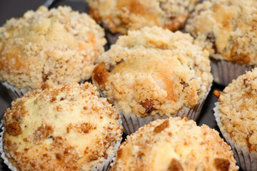 Freshly baked muffins with crumble on top. Homemade treats with apple crumble flavor.