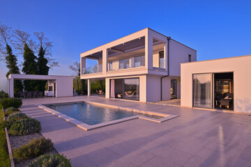 Modern luxury villa with pool, terrace, and minimalist architecture on a sunny day. Clean lines,...