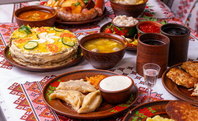 Large table with various traditional Ukrainian dishes, festive dinner, wide shot, close-up.