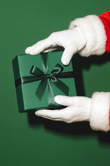 Santa&rsquo;s Hands Offering a Green Gift Box