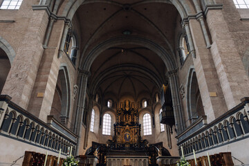 Fototapeta premium Interior view High Cathedral ceiling Saint Peter german Trier Dome. Architecture detail ornament sculptures angels saints ornate floral motifs radial composition.