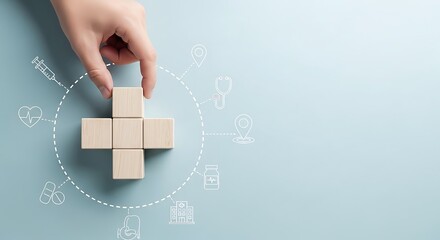 Hand placing wooden block to build a medical cross surrounded by healthcare service icons on blue background
