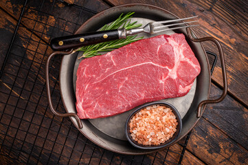 Ready for cooking Raw Rump beef steak with herbs. wooden background. top view