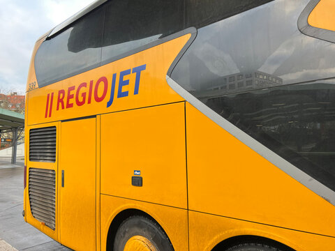 Bold yellow RegioJet intercity coach at bus station in Berlin - November 24, 2025. For European transport, travel and urban mobility advertising concepts