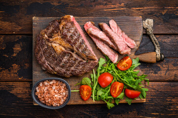 BBQ Grilled Rib eye steak on wooden board, roast  beef meat. wooden background. top view