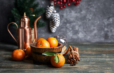 Christmas holiday composition with tangerines and coffee. Festive decorations and firtree on old wooden board in rustic style.