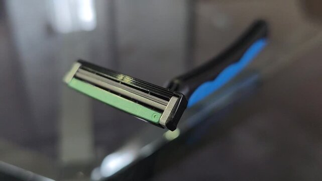 Sharp Triple-Blade Shaver on Reflective Surface - Men's Personal Care