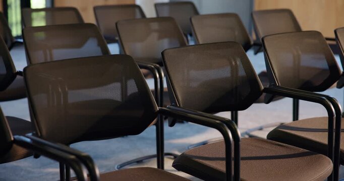 Chairs, business and empty conference hall for seminar, forum event or workshop with meeting venue. Seats, room and interior at convention center with rows for summit, trade show and furniture