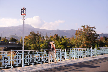 Pilgrims on International Bridge  Avenue on the Bidasoa river  that connects Hendaye with Irun on  Camino del Norte to Santiago de Compostela, Way St. James