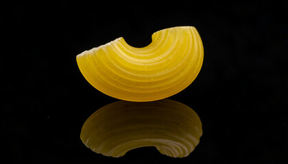 one macaroni elbow pasta on black backdrop, minimal composition, detailed ingredient close-up