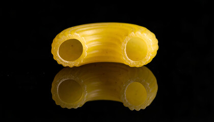 one macaroni elbow pasta on black backdrop, minimal composition, detailed ingredient close-up