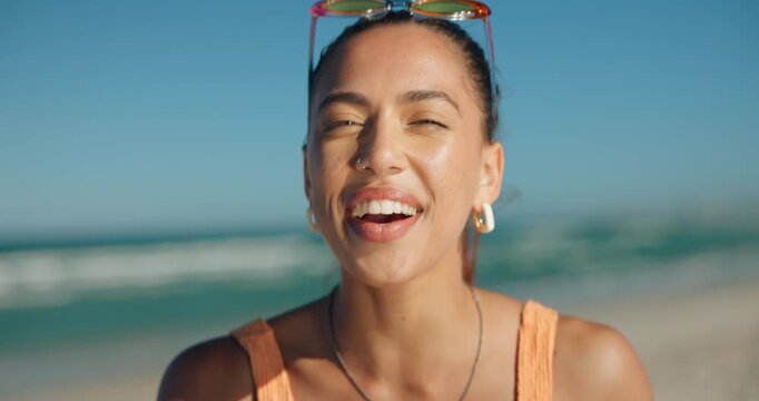 Face, girl and happy with peace sign on beach for travel adventure, weekend break or blowing kiss. Summer breeze, female tourist or smile at seaside for vacation getaway, fresh air or holiday freedom