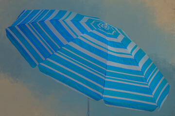 Vibrant blue and white striped beach umbrella seen from below against a soft colored cloudy summer sky