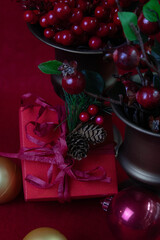 Christmas  decorations include red baubles, green foliage, pinecones, and a red  gift-wrapped item.