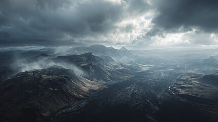 An atmospheric view of a dramatic, rugged mountain landscape beneath a stormy sky. The scene is both imposing and beautiful, featuring rolling hills and cloudy sky