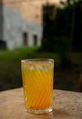 cocktail in a glass with a straw on a stone table.