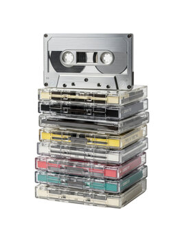 Close-up macro photograph of seven precisely stacked vintage audio cassette tapes, featuring a brushed silver type iv metal cassette, isolated on a clean white background. Analog nostalgia and retro