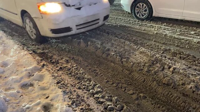 city motorists during snowfall and slush at rush hous