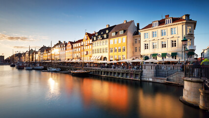 Copenhagen colored building in Nyhavn with blue sky and sun, Denmark