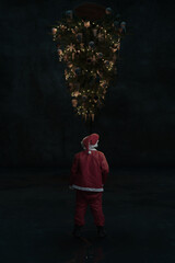 Digital Composited Santa Claus from Behind in Front of Rotated Christmas Tree