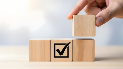 Wooden blocks with check mark symbol hand placing last cube complete task