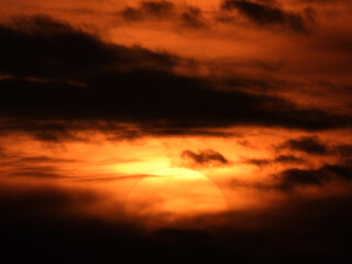 Fototapeta premium sun zoomed behind the clouds at the sunset over the Adriatic sea in Rovinj