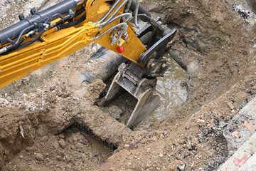 closeup of excavator bucket while digging
