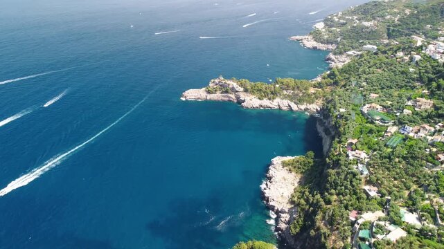 Amalfi coast from Punta Campanella near Sorrento. Amazing aerial view of speedboats from drone in summer season