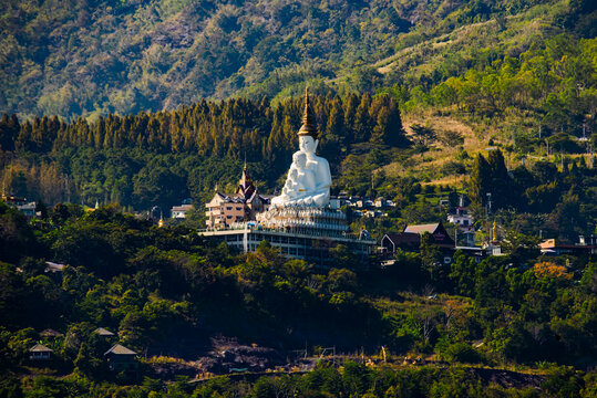 View of Wat Phra That Pha Sorn Kaew Temple with Five White Buddha Statues Against Lush Green Mountains in Khao Kho Phetchabun, Thailand.