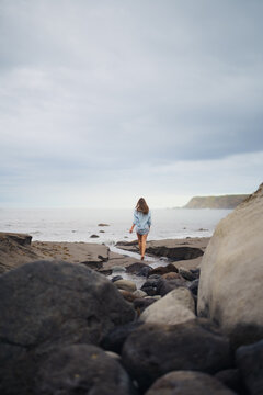 Girl Walking Along a Rocky Stream on Praia dos Moinhos Beach Toward the Atlantic Ocean, S&atilde;o Miguel, Azores