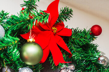 Festive Christmas tree decorations with a large red bow and ornaments