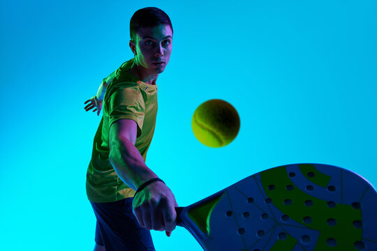 Padel athlete forward strike neon depth shot. Concept of digital sports promos, kinetic overlays, hero areas for landing pages, UI modules and branded content for sport-oriented platforms. - Powered by Adobe