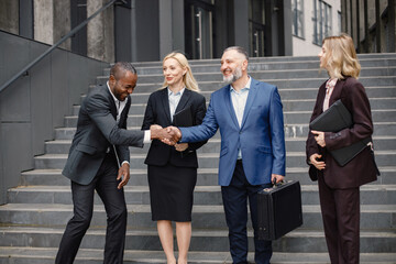 Business people standing and talk to each other in front of modern office