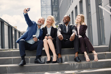 Business people sitting on a stairs and make a selfie
