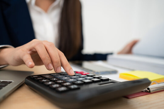 Financial Precision: A professional accountant meticulously calculates financial data, ensuring accuracy and efficiency in a focused work environment.