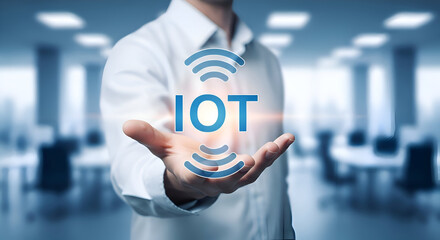 Businessman presenting the concept of the Internet of Things or IOT technology with glowing digital interface hovering over his open palm in a modern office setting
